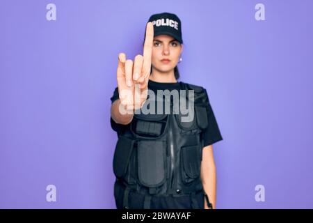 Young Police Woman Wearing Security Bulletproof Vest Uniform Over Purple  Background Pointing Down With Fingers Showing Advertisement Surprised Face  And Open Mouth Stock Photo - Download Image Now - iStock