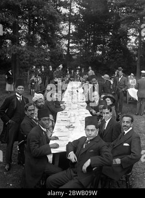 Worshippers and guests at the table at the Feast of Sacrifice, Eid, at the Mosque in Woking , Surrey on 8 October 1916 The Shah Jahan Mosque was the first purpose built mosque in Europe outside of Muslim Spain. The man standing up in the middle of the photograph, on the right, is a rare photograph of Duse Mohammed Ali, the first Muslim to have a printing press in Fleet Street, which he set up in c. 1913 Stock Photo