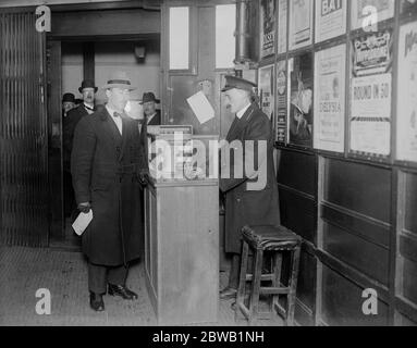 Liftman , ticket collector and booking clerk all in one . A novel electrically operated machine has been installed inside the lift on the Underground at Aldwych Station . It enables the lift man to issue and collect tickets and at the same time to control the working of his lift . The lift man issuing a ticket from the machine . 5 May 1922 Stock Photo