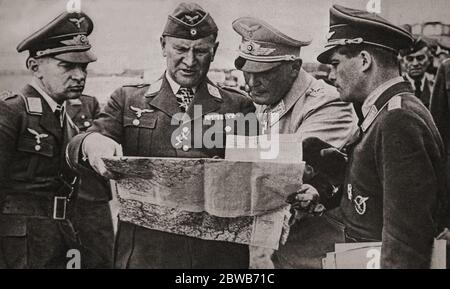 Luftwaffe Commander-in-Chief Hermann Göring in conversation with staff officers during the Battle of Britain. The Luftwaffe was officially created on 26 February 1935, with Göring as its commander-in-chief, who thought the RAF could be eliminated prior to the proposed invasion (Operation Sealion). He had been a celebrated First World War fighter pilot and was one of Hitler’s closest political associates. Stock Photo