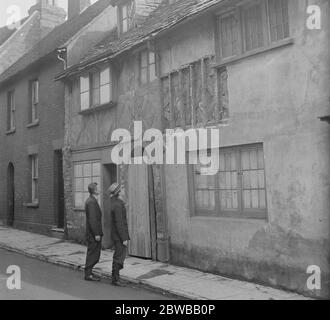 As the result of broken plaster , this old house in Church Street , Poole was examined by experts and found to be a continuation of a 16th century half timbered building and has been scheduled for preservation , instead of being demolished as part of a slum clearance scheme . 27th March 1936 Stock Photo