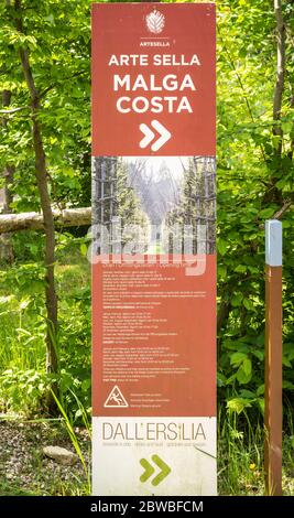 Sign indicating mountain routes and touristic information in the Arte Natura route - Arte Sella - the park with many artworks - Borgo Valsugna -Italy Stock Photo