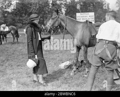 Polo at the Ranelagh Club , West London . At the match between the , Royal Horse Artillery Subalterns versus Foston Hall in the Junior Colts Cup tie , Mrs Daniell holds a polo pony as it is saddled up . 28 May 1934 Stock Photo