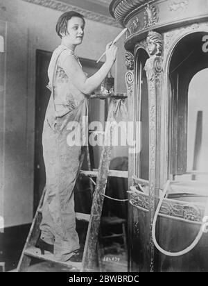 Gloria Gould Bishop as painter . Mrs Gloria Gould Bishop , youngest daughter of the late George Jay Gould , the American millionaire , re decorating the stalls of the New Embassy Theatre , New York , which she is to manage . 10 August 1925 Stock Photo