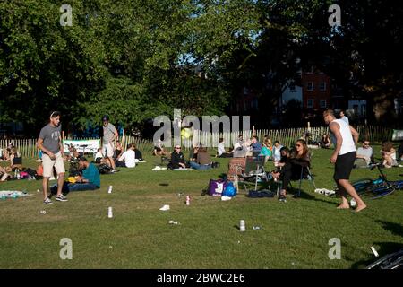 Hackney,London May 2020 during the Covid-19 (Coronavirus) pandemic. London Fields. A group of young men play a ball game with beer cans as markers. Stock Photo