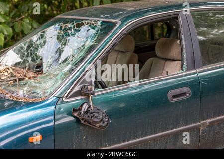 Damage to the car, broken glass and side mirror. Stock Photo