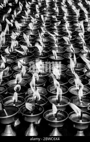 many tea lamps in Nepali temple Stock Photo