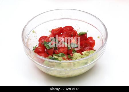 Tasty guacamole meal in glass bowl on white background Stock Photo