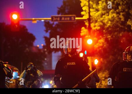 Minneapolis, USA. 31st May, 2020. A riot police officer stands in formation in Minneapolis, the United States, on May 30, 2020. Minnesota Governor Tim Walz on Saturday activated 'full mobilization' of the Minnesota National Guard after four straight nights of violent protests in the midwest state's biggest city Minneapolis over the death of George Floyd, an unarmed black man, in police custody. Credit: Angus Alexander/Xinhua/Alamy Live News Stock Photo