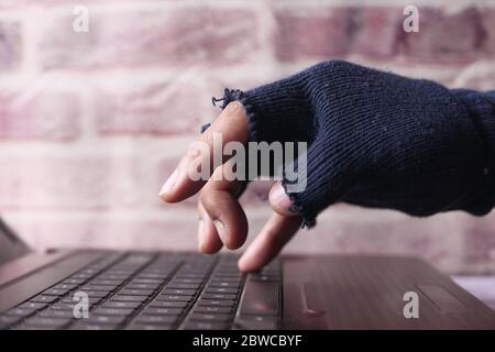 hacker hand stealing data from laptop at night  Stock Photo