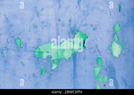 Old ragged cracked blue and green painted surface with rusty stains Stock Photo