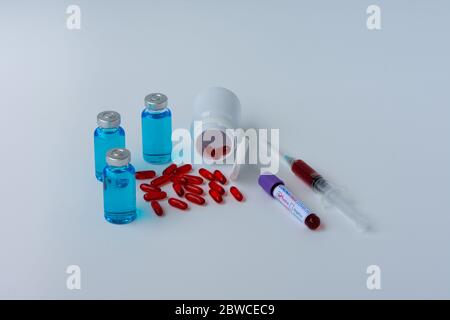 Coronavirus (COVID-19) infected blood test samples, vaccine vials, and pills. Concept of a prevention and treatment against Coronavirus. Stock Photo