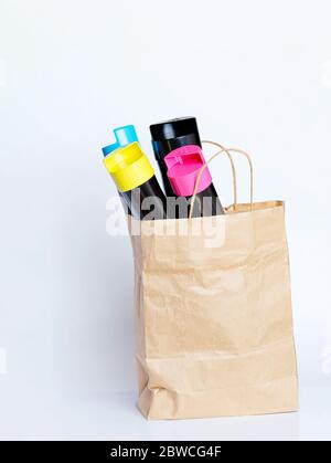 Set of cartridges for color laser printing in a paper bag on a gray background Stock Photo