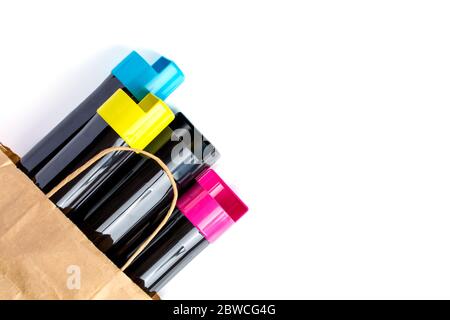 Set of cartridges for color laser printing lie on a table in a paper bag on a white background Stock Photo