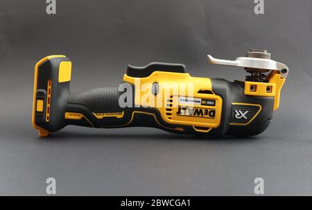 OTTERY ST MARY, DEVON - FEBRUARY 6TH 2020: Dewalt Cordless Multi Tool with the battery removed on a black background. Stock Photo