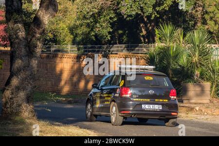 Alberton, South Africa - a private security company vehicle patrols a residential street during lockdown in the country image in horizontal format Stock Photo