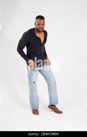 Pensive Black man in a black shrit Stock Photo