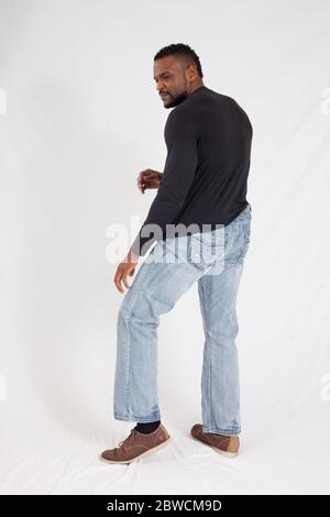 Pensive Black man in a black shrit Stock Photo