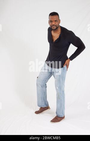 Pensive Black man in a black shrit Stock Photo