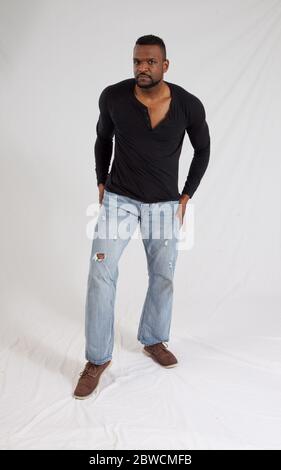 Pensive Black man in a black shrit Stock Photo