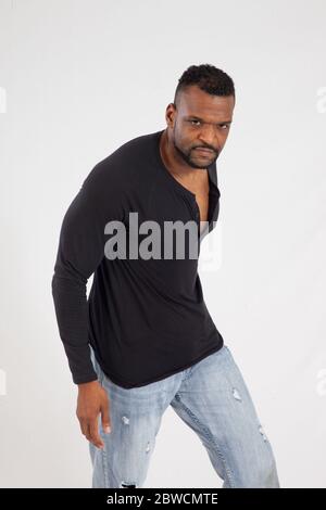 Pensive Black man in a black shrit Stock Photo