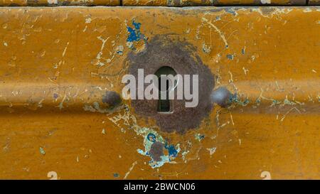 Close-up of rusty metallic keyhole on old metal mailbox Stock Photo