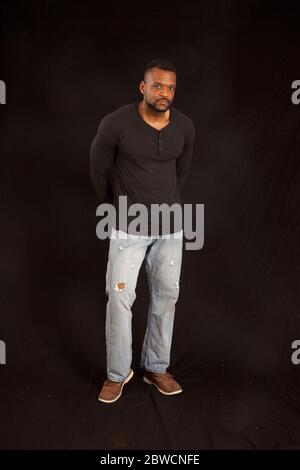 Pensive Black man in a black shrit Stock Photo