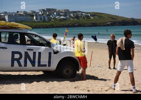 Newquay Fistral Beach Cornwall. - Return of lifeguards 2020 post covid lockdown, Lifeguards have returned to a small number of beaches on the north Cornish coast - Pictured here wearing suitable PPE and face masks to comply with the Covid safe message. Stock Photo