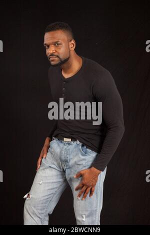 Pensive Black man in a black shrit Stock Photo