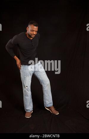 Pensive Black man in a black shrit Stock Photo