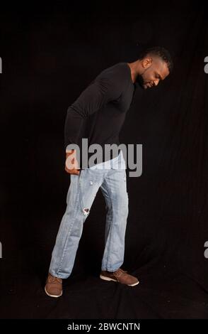 Pensive Black man in a black shrit Stock Photo