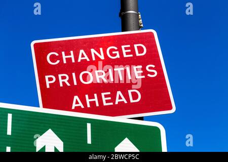 Red 'Changed Priorities Ahead' sign Stock Photo