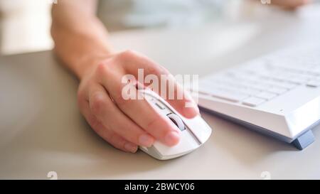 the developer works at computer, uses the mouse Stock Photo
