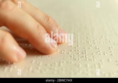 Braille reading. Blind man reads a book in braille Stock Photo