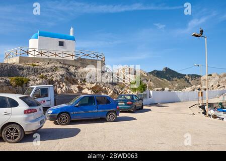 RHODES, GREECE - May 18, 2018: Port of Kolymbia whit white church on the rocks Stock Photo