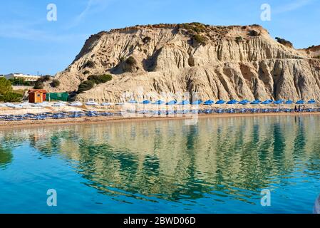 Beautiful Kolymbia beach with rocks reflected in water, Rhodes island. Greece Stock Photo
