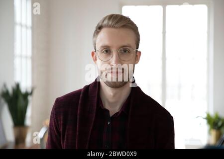 Young blonde employee worker in glasses looking at camera. Stock Photo