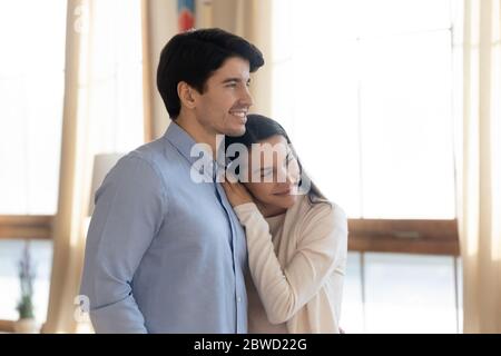 Happy young couple look in distance planning future together Stock Photo