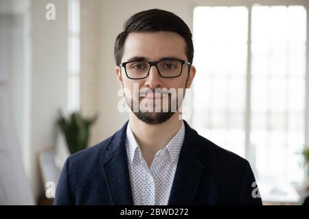 Head shot close up portrait of young confident businessman. Stock Photo