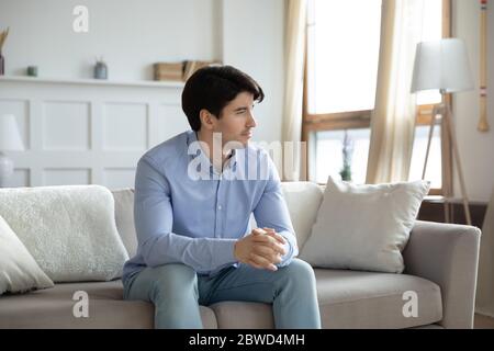 Pensive young man look in distance thinking Stock Photo