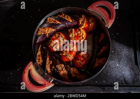 Top view of turkish eggplant kebab in pot or cooker with tomatos and minced meat, ready to cook, patlican kebab Stock Photo