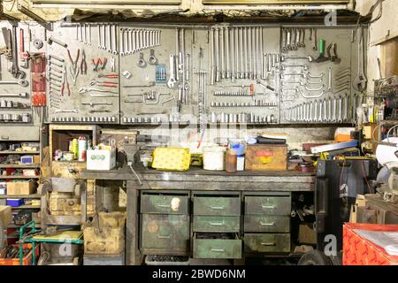 Tools in a car mechanic's garage with old drawers Stock Photo