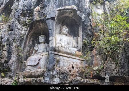 Buddha statues carved into hillside at Lingyin (Souls Retreat) Temple in Hangzhou, China. The vast complex is one of the most famous Buddhist Temples Stock Photo