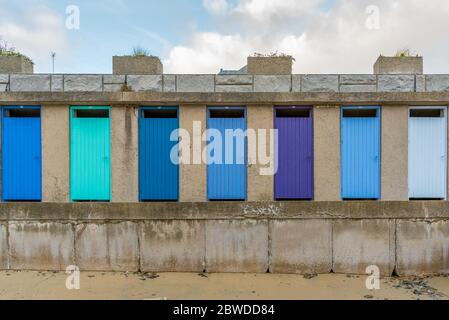Row of colorful beach cabin wooden doors painted with different shades of blue Stock Photo
