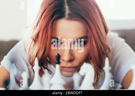 concentrated beautiful girl playing chess on self isolation, selective focus Stock Photo