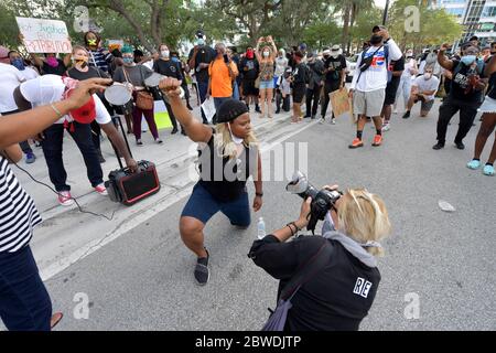 FORT LAUDERDALE, FL - MAY 31: A protester holds a sign during a rally in response to the recent death of George Floyd in Fort Lauderdale, Florida on May 31, 2020. - Thousands of National Guard troops patrolled major US cities after five consecutive nights of protests over racism and police brutality that boiled over into arson and looting, sending shock waves through the country. The death of an unarmed black man, George Floyd, at the hands of police in Minneapolis ignited this latest wave of outrage in the US over law enforcement's repeated use of lethal force against African Americans on May Stock Photo