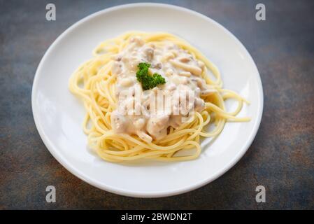 Spaghetti italian pasta served on white plate with parsley in the restaurant italian food and menu concept / spaghetti carbonara Stock Photo