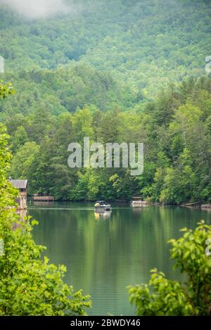 Family enjoying a pontoon boat ride on Lake Rabun in the Northeast Georgia Mountains in Lakemont, Georgia. (USA) Stock Photo