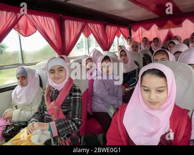 Elementary school services for girls. An Islamic school where girls should wear scarves and dress uniforms. Girl students in school service. Stock Photo