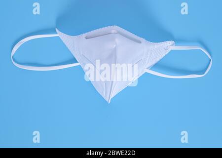 N95 respirator face mask on blue background N95 a heavy duty protective mask designed to filter out 95 percent of airborne particles Stock Photo